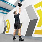 Male athlete performing wall ball exercise