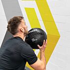 Male athlete exercising with wall ball