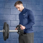 Male athlete adding 5kg weight plate to barbell