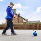 Young boy with blue hammer on playground