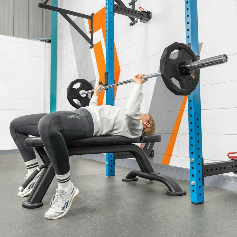 Female athlete performing barbell chest press