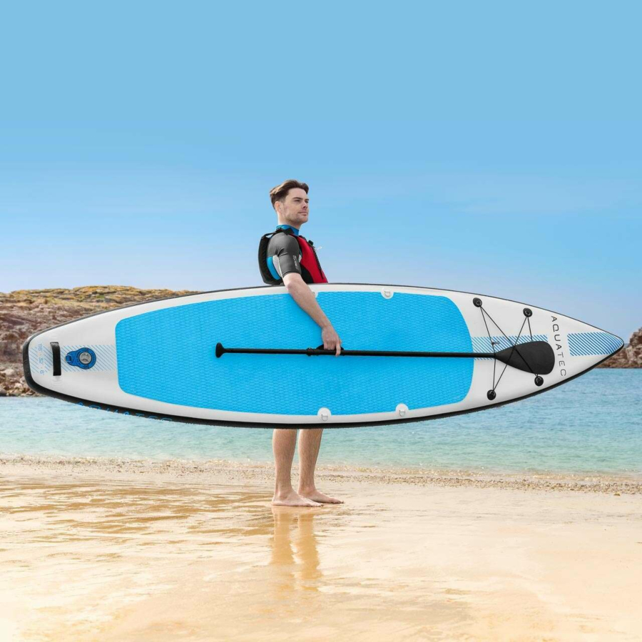 man with paddle board on the beach